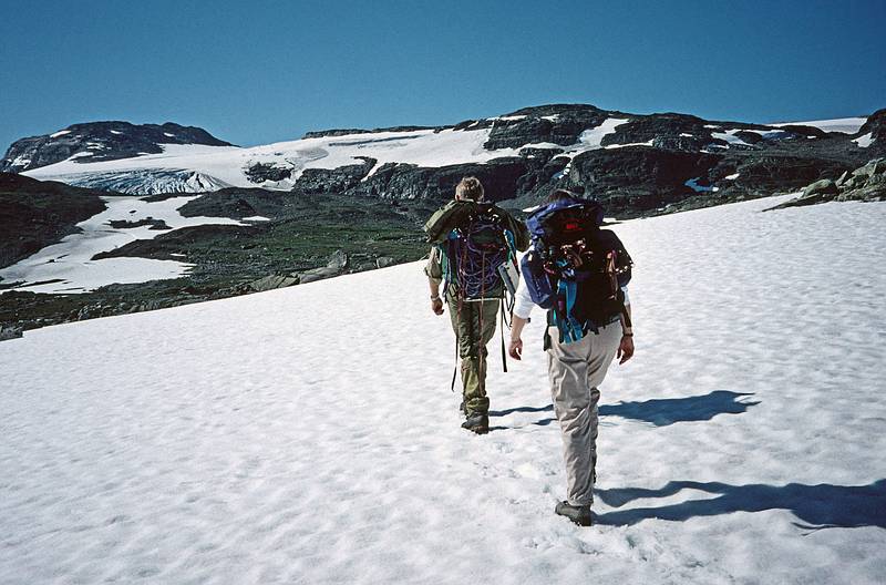 August 5, 1997 - From Finse to the Hardangerjkulen (glacier) and back, Norway.<br />Torger and Joyce hiking across the snow and heading for the glacier.