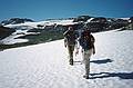 August 5, 1997 - From Finse to the Hardangerjkulen (glacier) and back, Norway.<br />Torger and Joyce hiking across the snow and heading for the glacier.