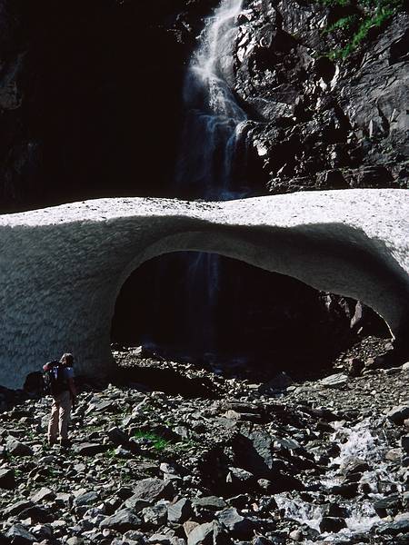 August 5, 1997 - Finse to Flm via Myrdal, Norway.<br />Joyce inspecting an arch under the snow that the stream carved.