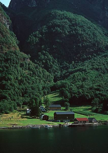 August 6, 1997 - In and around Flam, Norway.<br />A fjords tour to Gudvangen and back.<br />A small farm and dock at the edge of the fjord.