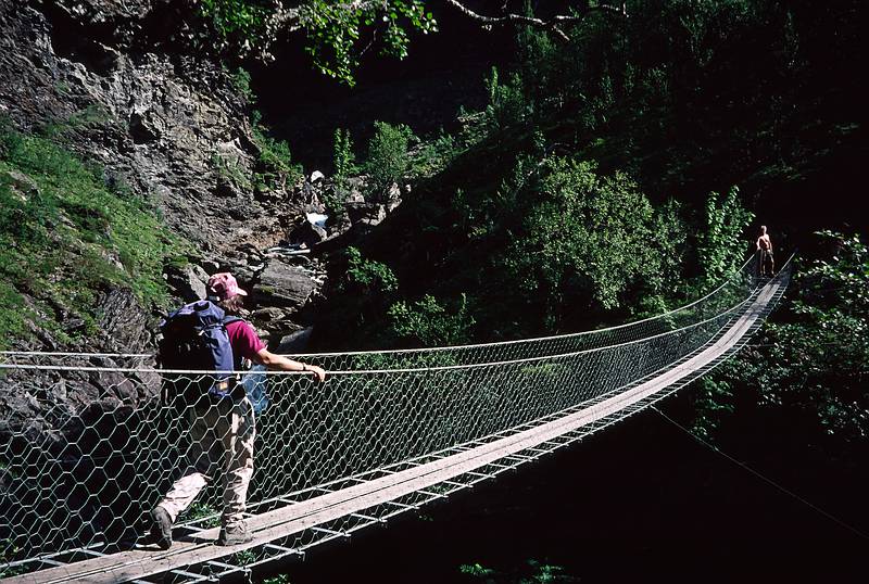 August 7, 1997 - Aurlandsdalen (Aurland valley) hike, Norway.<br />Joyce crossing a suspension bridge while Torger watches at the far end.