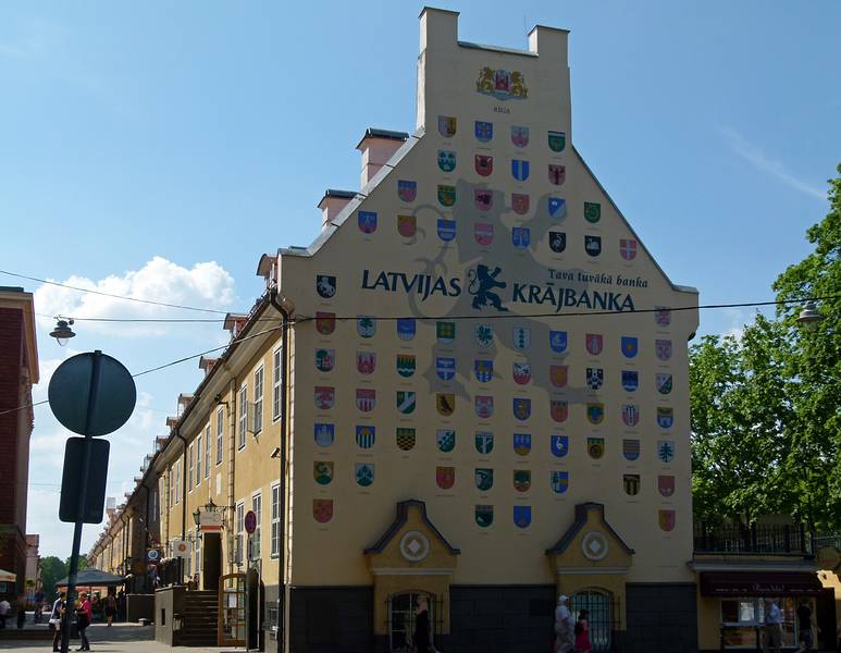 Latvia Savings Bank ad with coat of arms of cities in the country<br />on former army barracks building (Jacob's Barracks).<br />June 1, 2011 - Riga, Latvia.