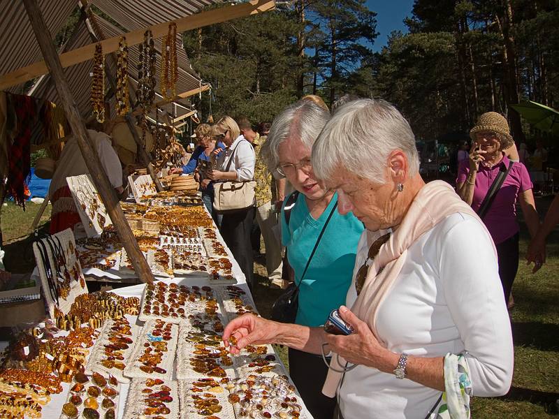 Joyce and Baiba examining the local amber jewelry.<br />Arts and crafts fair at the Latvian Ethnographic Open Air Museum.<br />June 4, 2011 - Riga, Latvia.