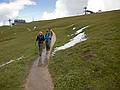 Joyce, Melody, and Sati on the trail. By the way, that is fresh snow by the side of the trail.<br />Seceda cable car terminal in back.<br />Hike from Seceda cable car terminal to Puez hut.<br />July 26, 2011 - NE of St. Ulrich/Ortisei, Italy.