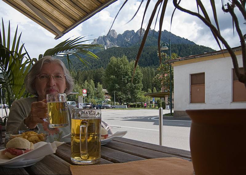 Joyce (and I) having some beer and speck sandwitches<br />while waiting for the bus to take us to Cortina.<br />July 28, 2011 - Toblack/Dobbiaco, Italy.